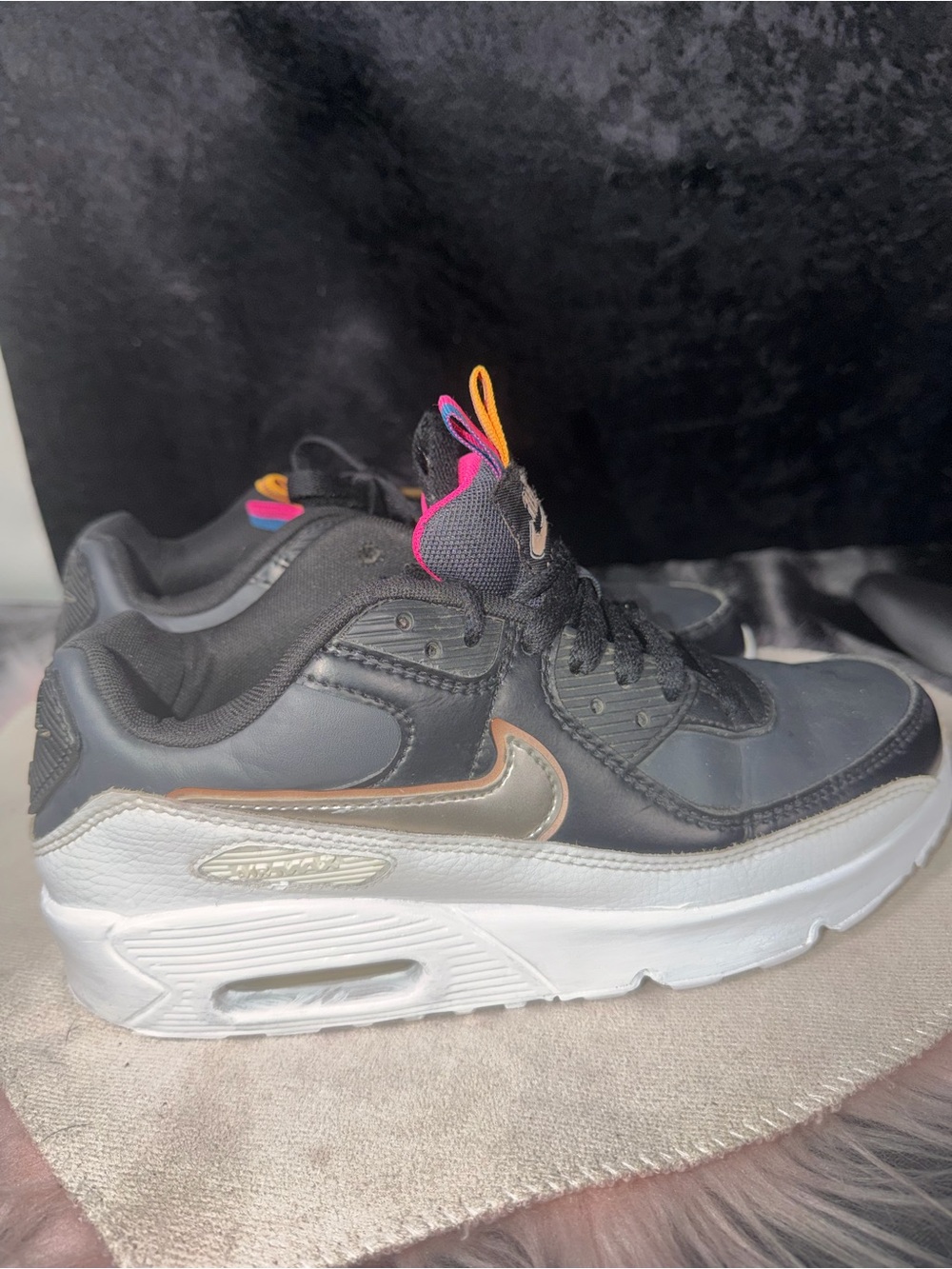 Nike Women’s Black Sneaker with Metallic Pink Accent and Orange Pull Tabs